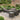 Dark brown outdoor rattan side table in garden patio setting