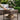 Brown outdoor end table beside garden sofa