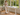 K3021 white glass standing desk in a bright British conservatory with a relaxed home working lifestyle setting