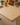 K3101 standing desk close-up showing the natural wood grain tabletop finish in a warm home office setting
