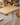 K3101 wooden standing desk with chamfered edge in a warm home office, showing the rounded desktop corner, built-in USB hub and natural wood grain finish