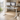 Vetra white glass standing desk with drawer in a bright modern living room workspace with dual monitors and USB charging